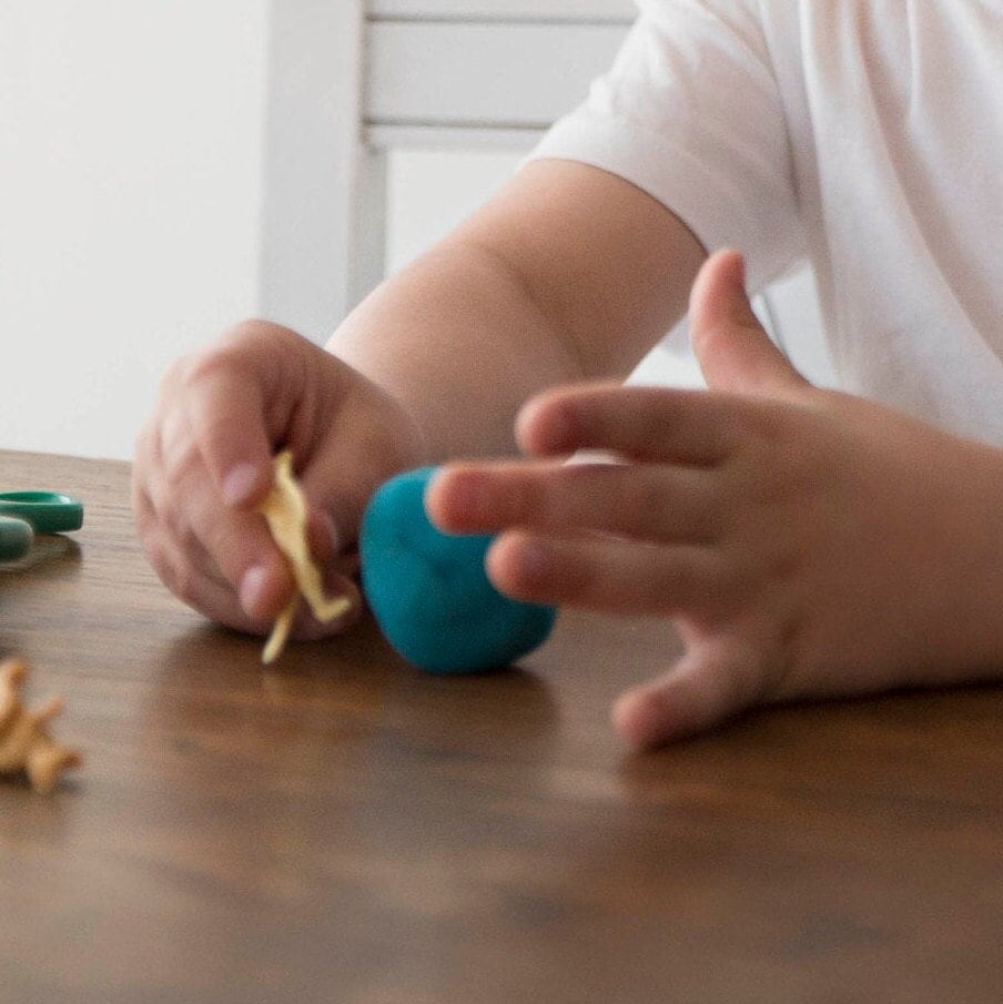 child's hand with homemade playdough