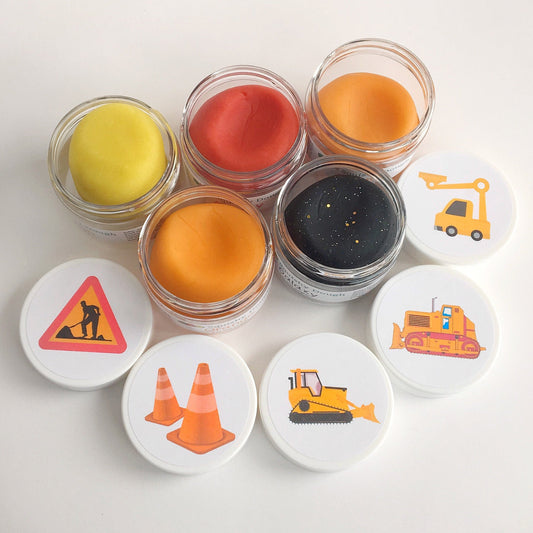 five scented playdoughs with construction stickers on lids